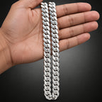Silver chain bracelet on a person's wrist with a dark background