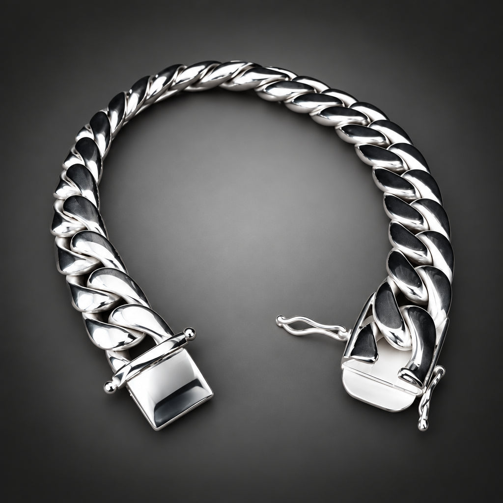 A polished silver Cuban link chain bracelet with a square clasp, displayed on a rustic wood slice against a solid black background.