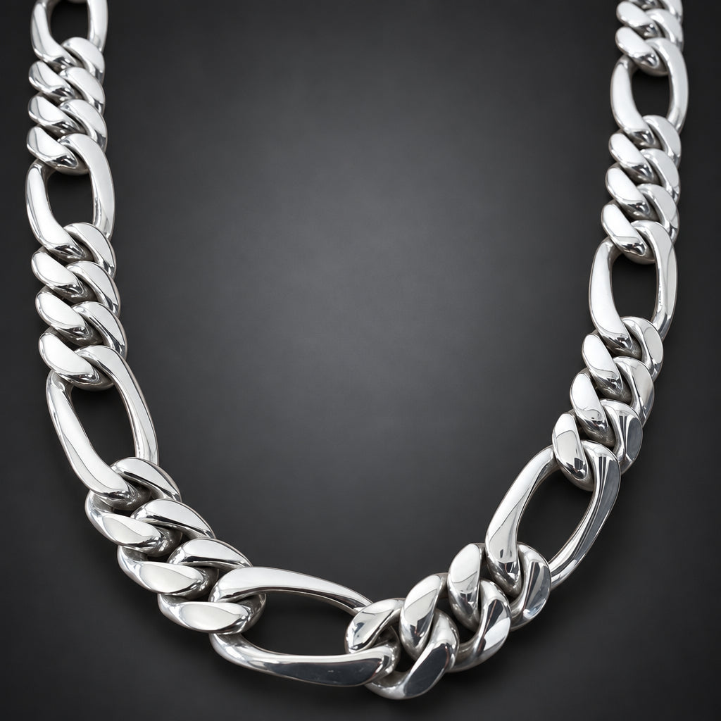A polished silver-tone Cuban link chain necklace displayed on a light brown wooden surface.
