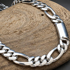 Silver chain bracelet on a wooden surface