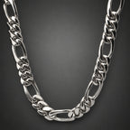 Silver chain necklace on a light gray background