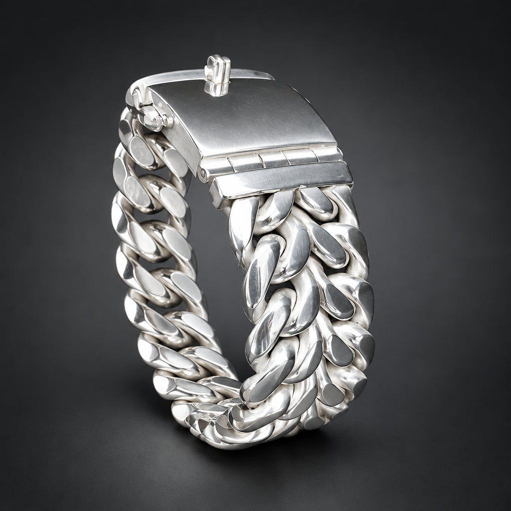 Silver bracelet with intricate design on a wrist against a dark background