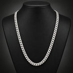 Gold chain on a black textured surface