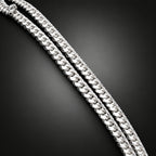 Gold chain on a dark surface