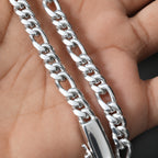 A close-up of a silver-toned metal chain necklace draped over a person's hand, showing the chain links and clasp in detail.