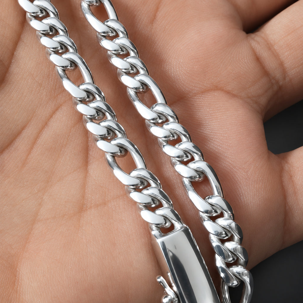 A close-up of a silver-toned metal chain necklace draped over a person's hand, showing the chain links and clasp in detail.
