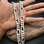 Silver chain bracelet on a hand with a wooden background