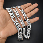 Three silver chain bracelets on a hand against a black background
