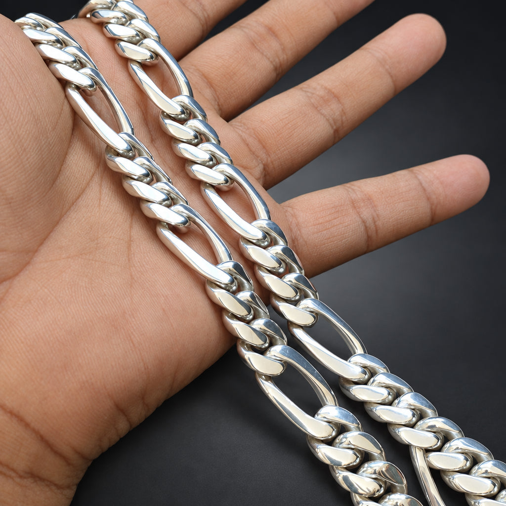 Silver chain bracelet on a hand with a dark background