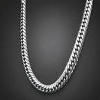 Silver chain necklace on a dark background
