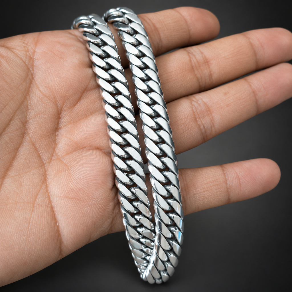 Silver braided bracelet on a hand against a dark background