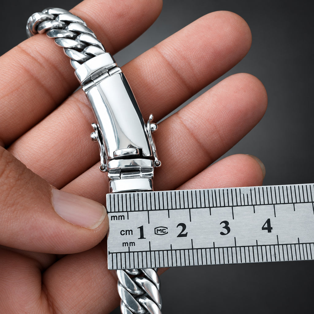 Silver bracelet being held with a ruler for measurement