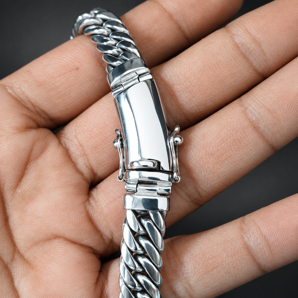Silver braided bracelet held in a hand against a blurred background