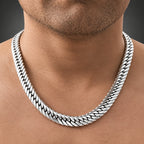 Close-up of a person wearing a silver chain necklace.