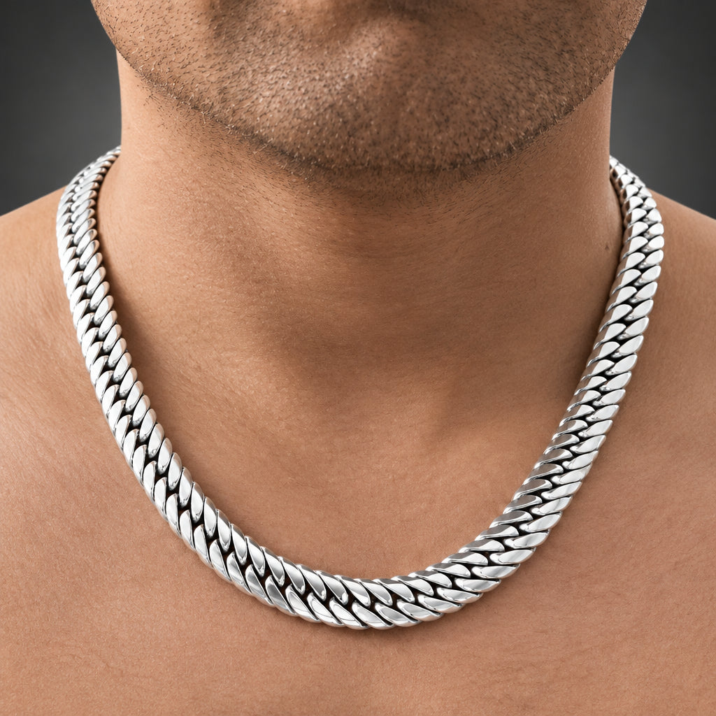 Close-up of a person wearing a silver chain necklace.