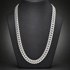 Silver chain necklace on a dark textured background