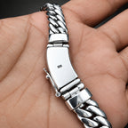 Silver bracelet on a person's wrist with a close-up view
