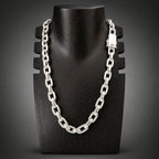 Silver chain necklace on a black mannequin bust