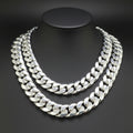A thick silver Cuban link chain necklace displayed on a black mannequin bust against a dark gray background.