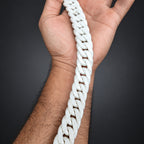 White braided rope held in a hand with a blurred background
