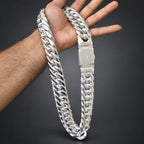 Silver chain bracelet being held up against a wooden background