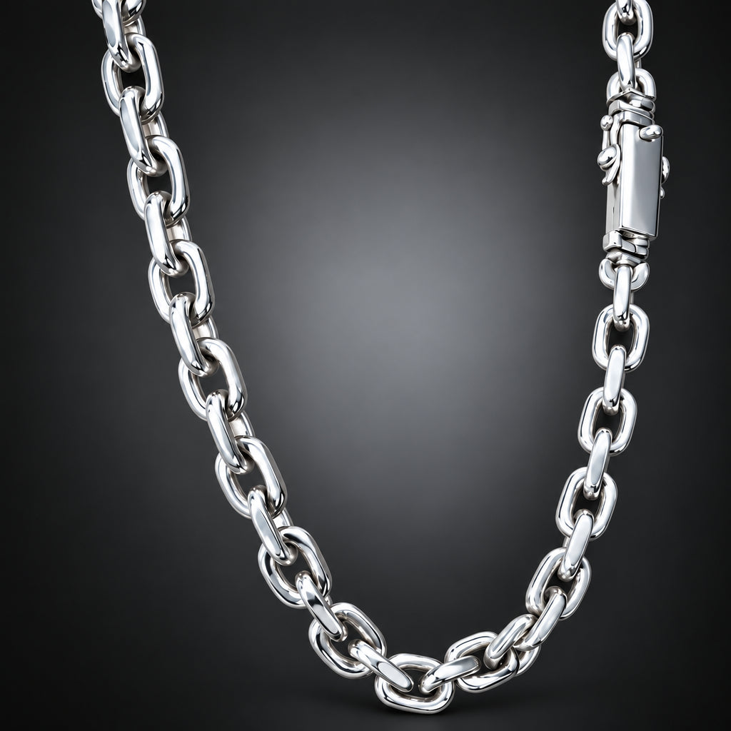A polished silver-tone chain necklace with large oval links and a matching lobster clasp, photographed against a dark gray to black gradient background.