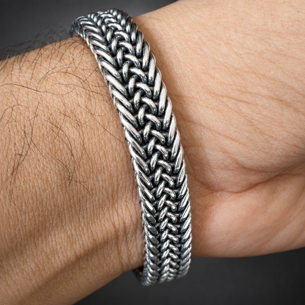 Silver braided bracelet on a wrist