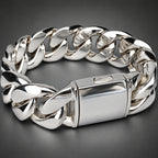 A polished silver-tone metal chain bracelet with a rectangular clasp, photographed close-up on a light neutral background.