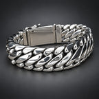 Silver chain bracelet on a wooden surface with a dark background