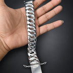Silver chain bracelet on a hand against a dark background