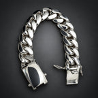 Silver chain bracelet on a hand against a neutral background