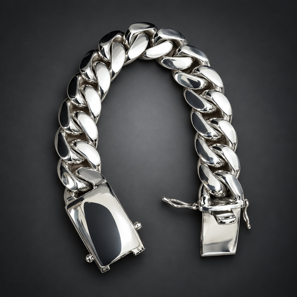 Silver chain bracelet on a hand against a neutral background