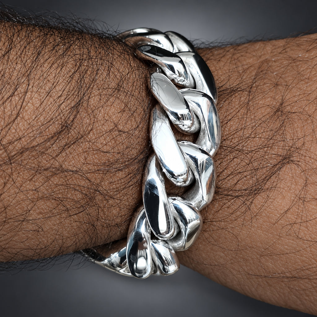 Silver chain bracelet on a wrist with a neutral background