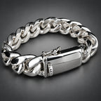 A polished silver-tone Cuban link bracelet with a rectangular ID plate and clasp, photographed on a dark gray gradient background.