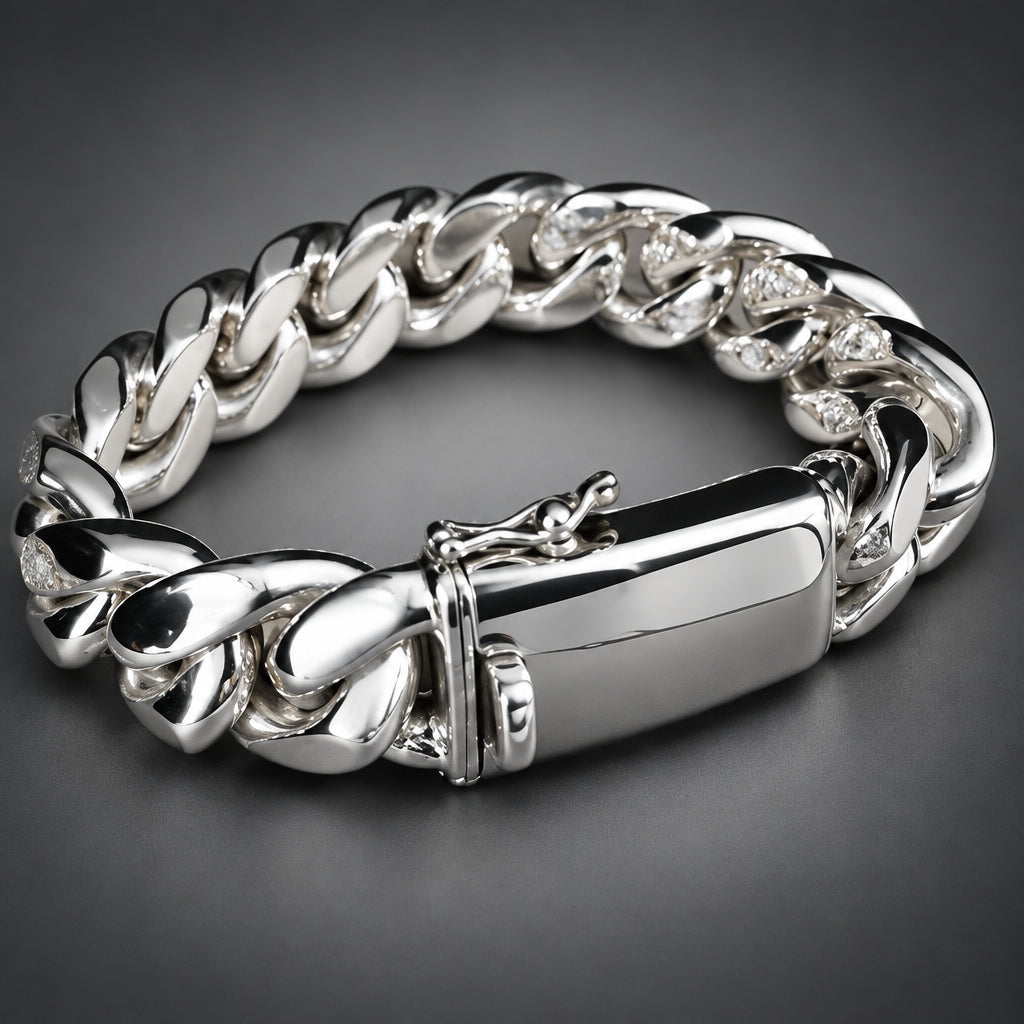 A polished silver-tone Cuban link bracelet with a rectangular ID plate and clasp, photographed on a dark gray gradient background.