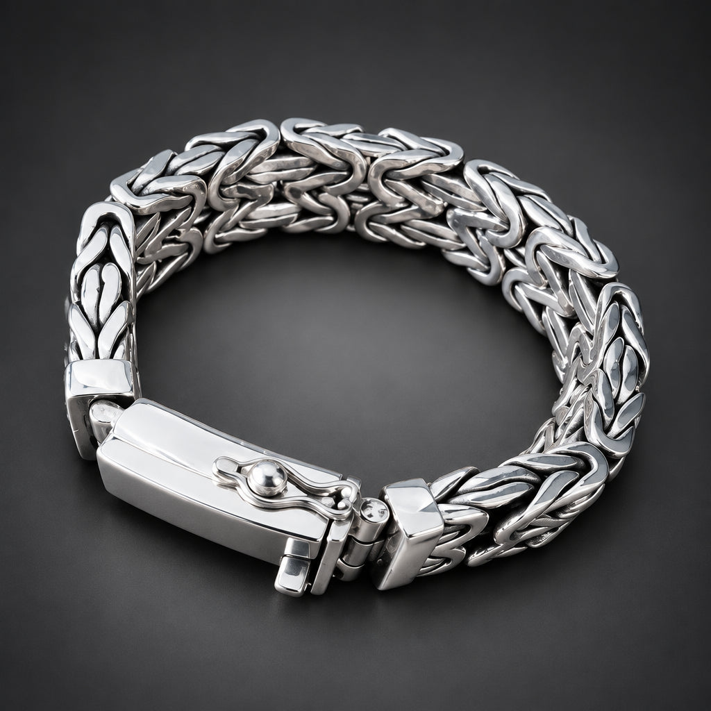 Silver braided bracelet on a hand with a dark background