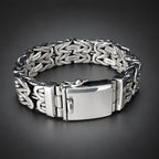 Silver bracelet with intricate design on a wooden surface