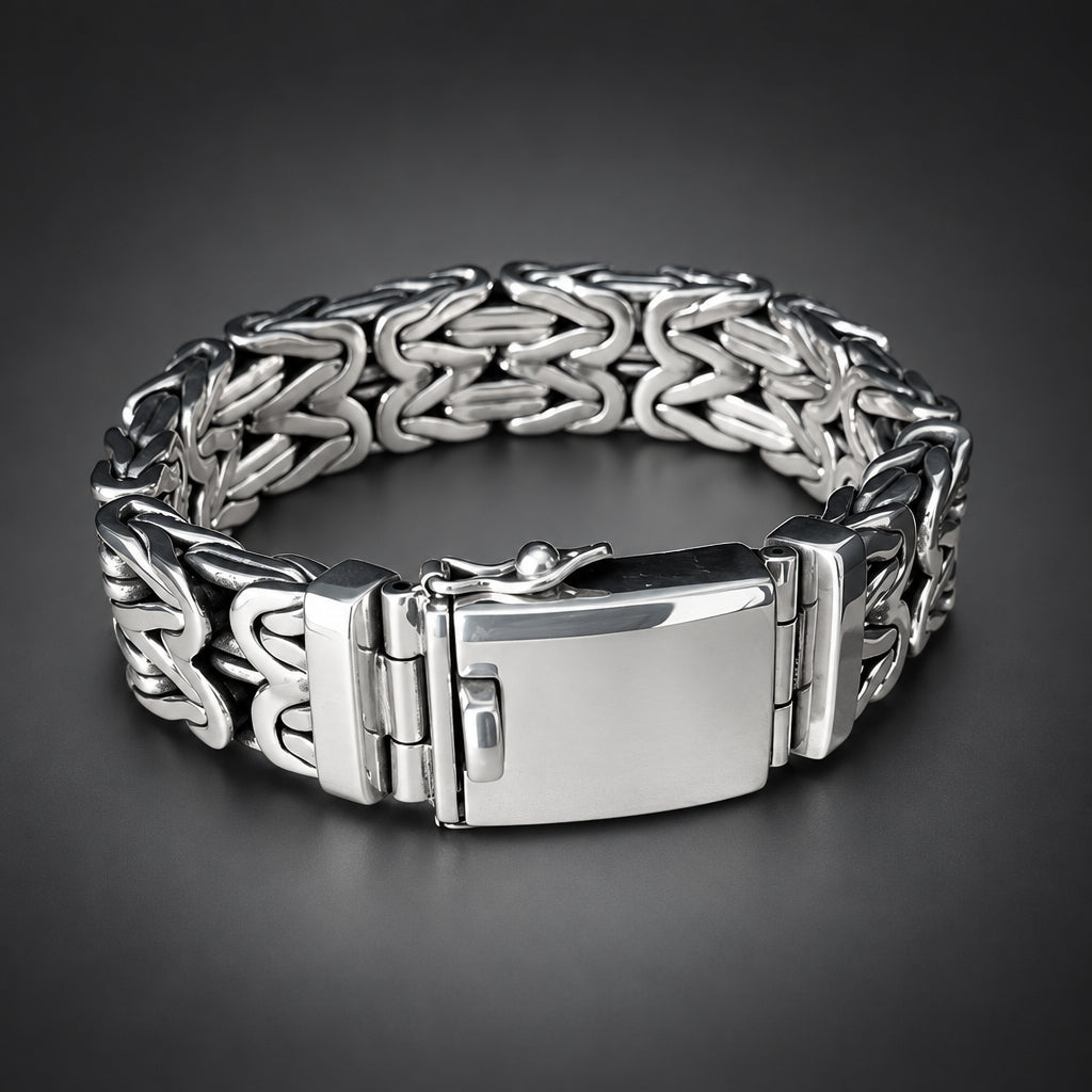 Silver bracelet with intricate design on a wooden surface