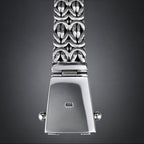 Silver watch with decorative band on a wooden surface