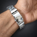 Silver bracelet on a wrist with a dark background