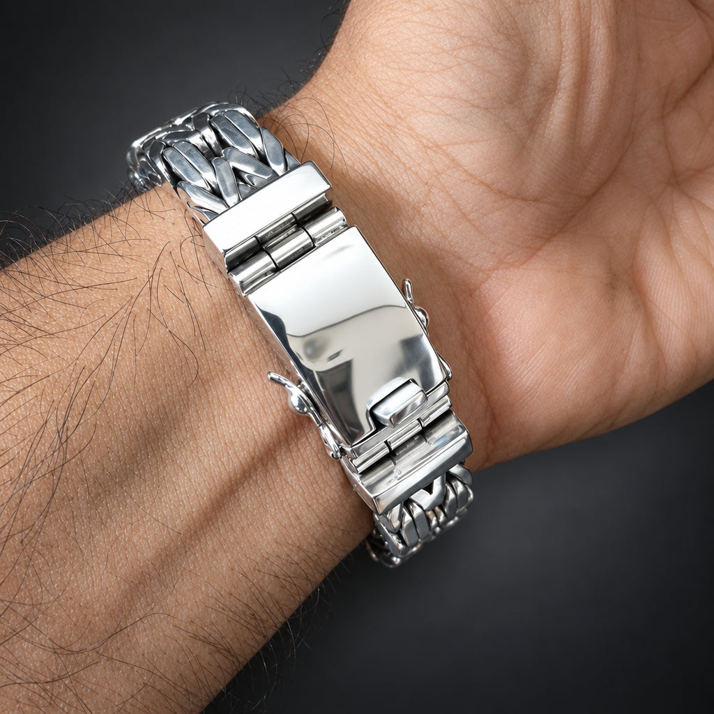 Silver bracelet on a wrist with a dark background
