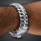 Silver chain bracelet on a wrist with a blurred background