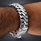 Silver chain bracelet on a wrist with a blurred background