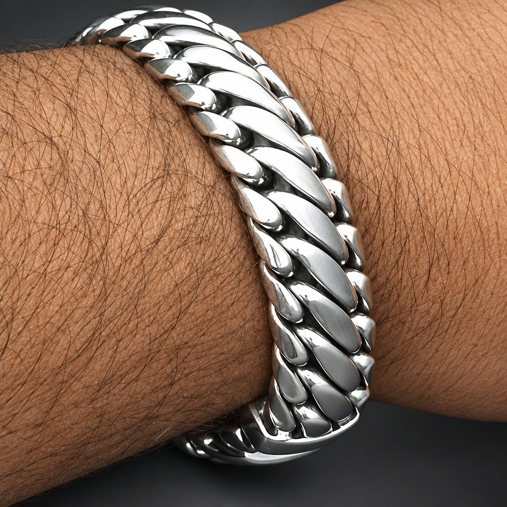 Close-up of a silver chain bracelet on a wrist with visible skin texture.