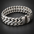 Close-up of a silver chain bracelet on a black background