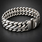 Close-up of a silver chain bracelet on a black background