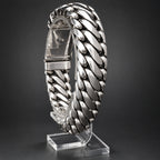 Silver braided bracelet on a black background