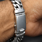 Close-up of a silver braided bracelet on a wrist.