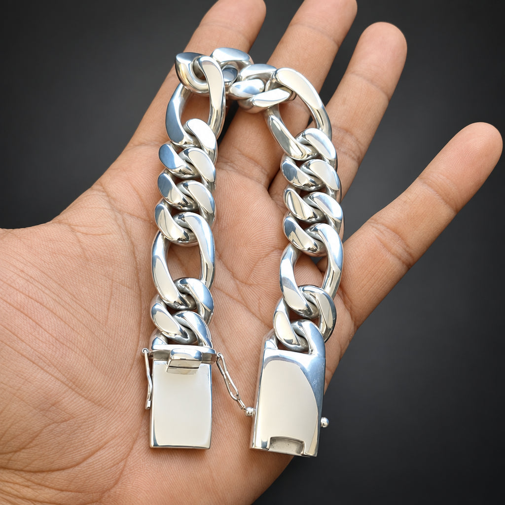 Gold and silver chain bracelet on a hand against a black background