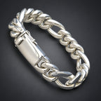 Silver chain bracelet on a hand against a black background